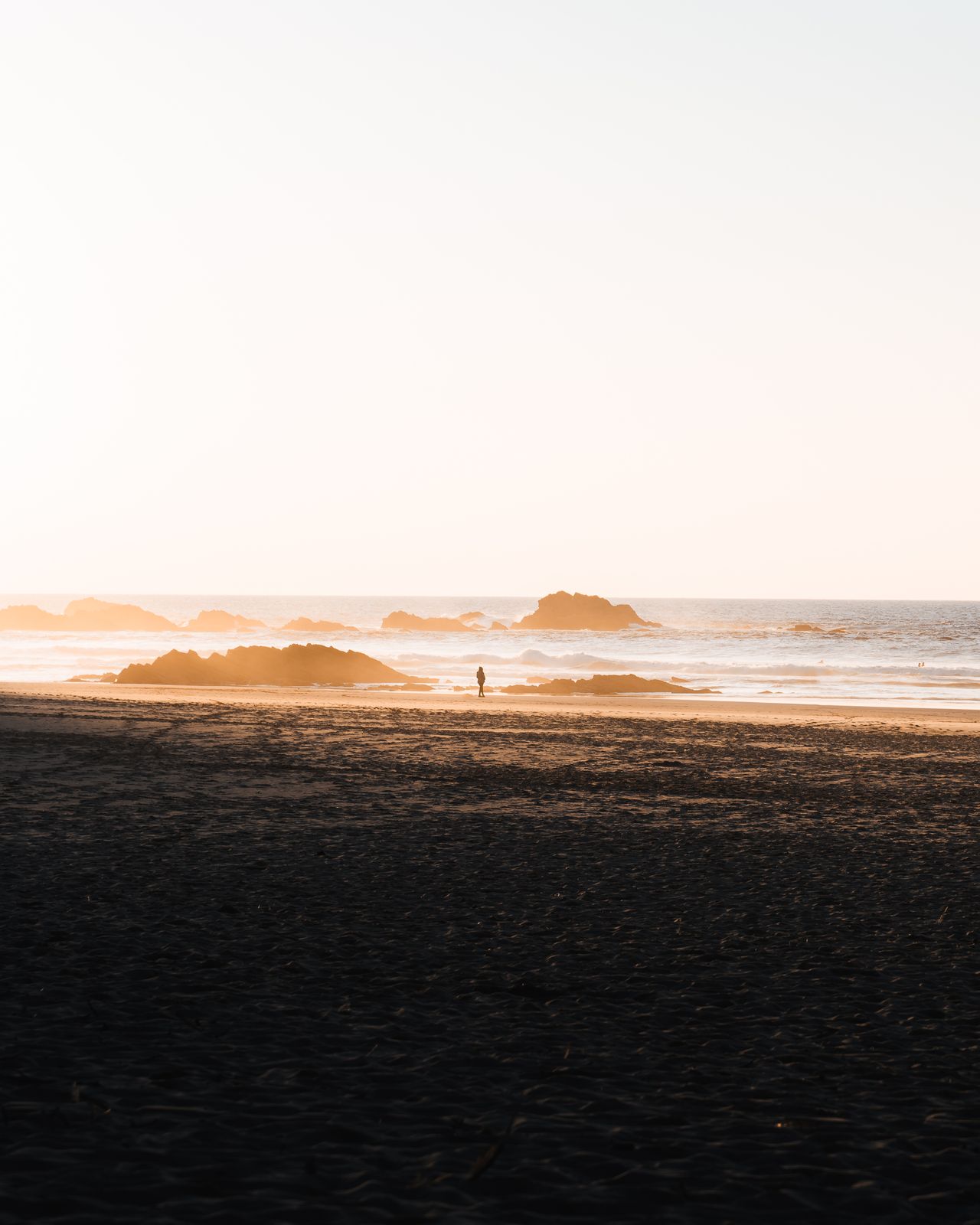 Minimal beach scene with a distant lone figure