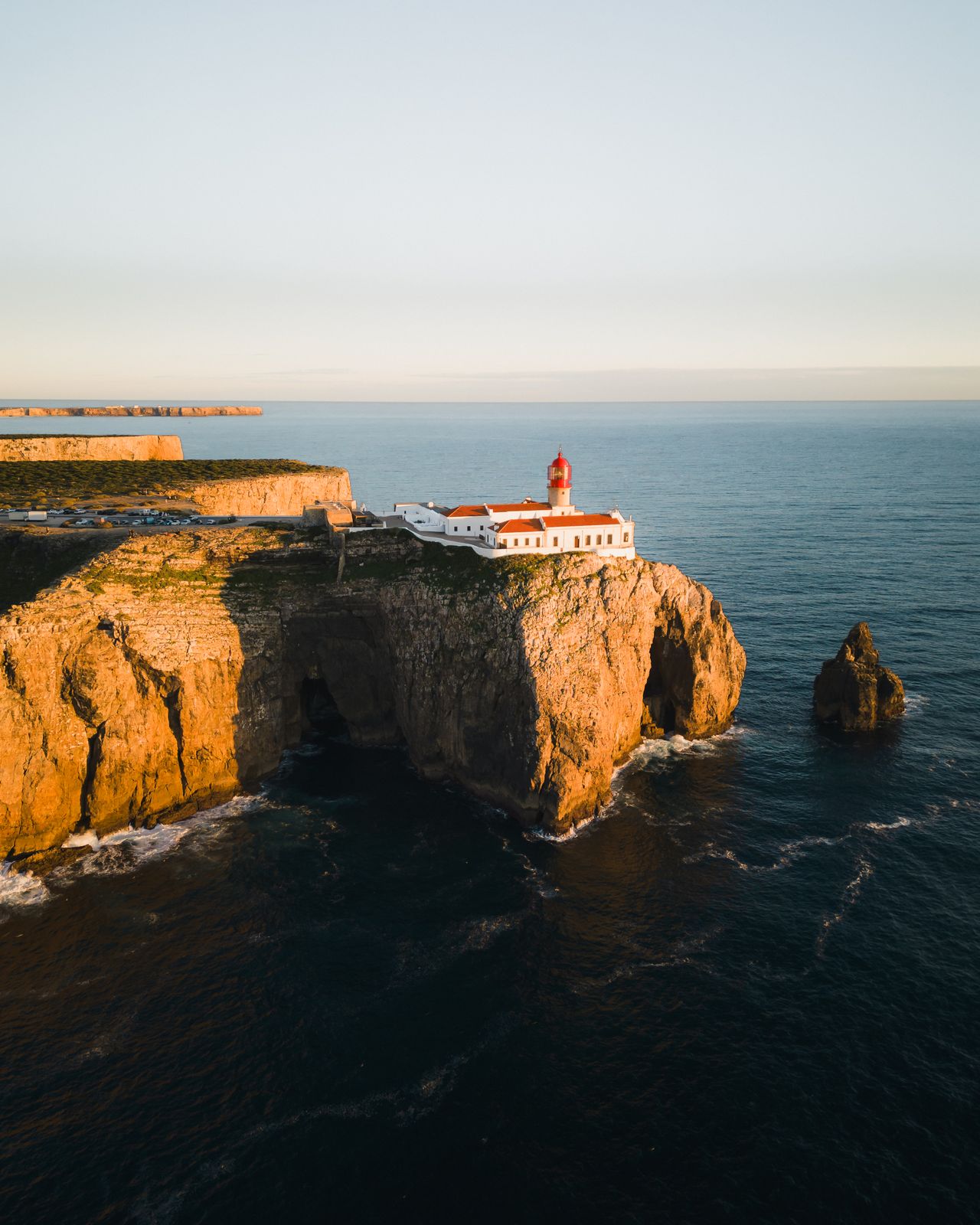 Aerial view of a clifftop fort at golden hour