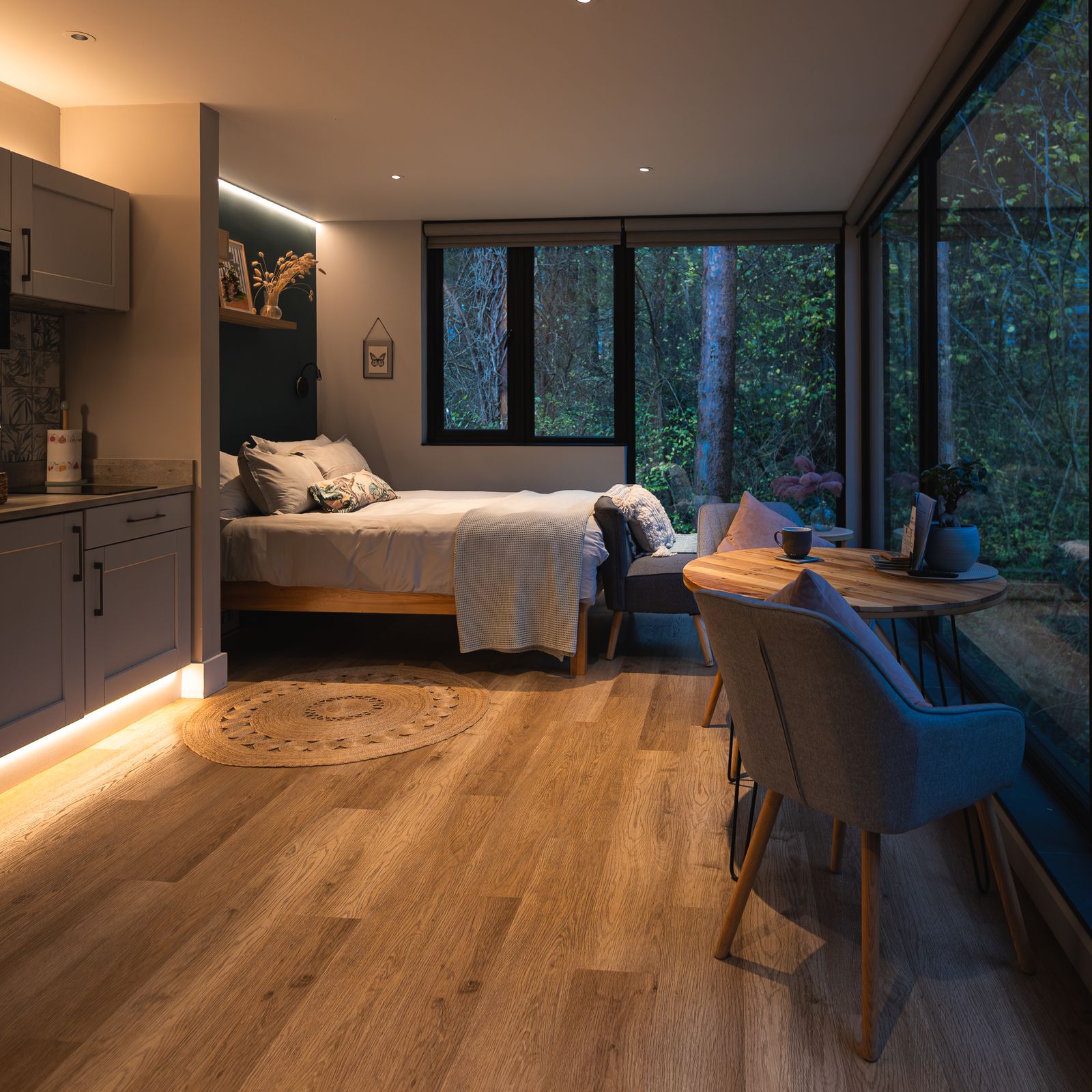 Open plan interior with kitchen and bed under the window