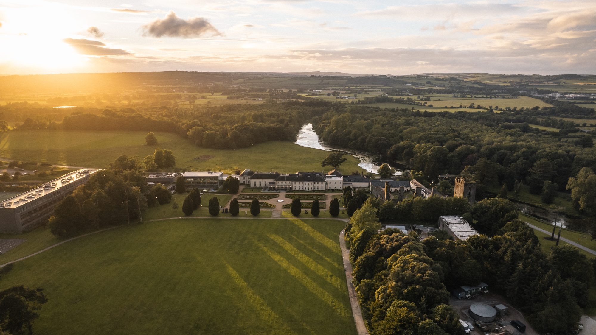Aerial view of Castlemartyr Resort and its gardens at golden hour, Co. Cork