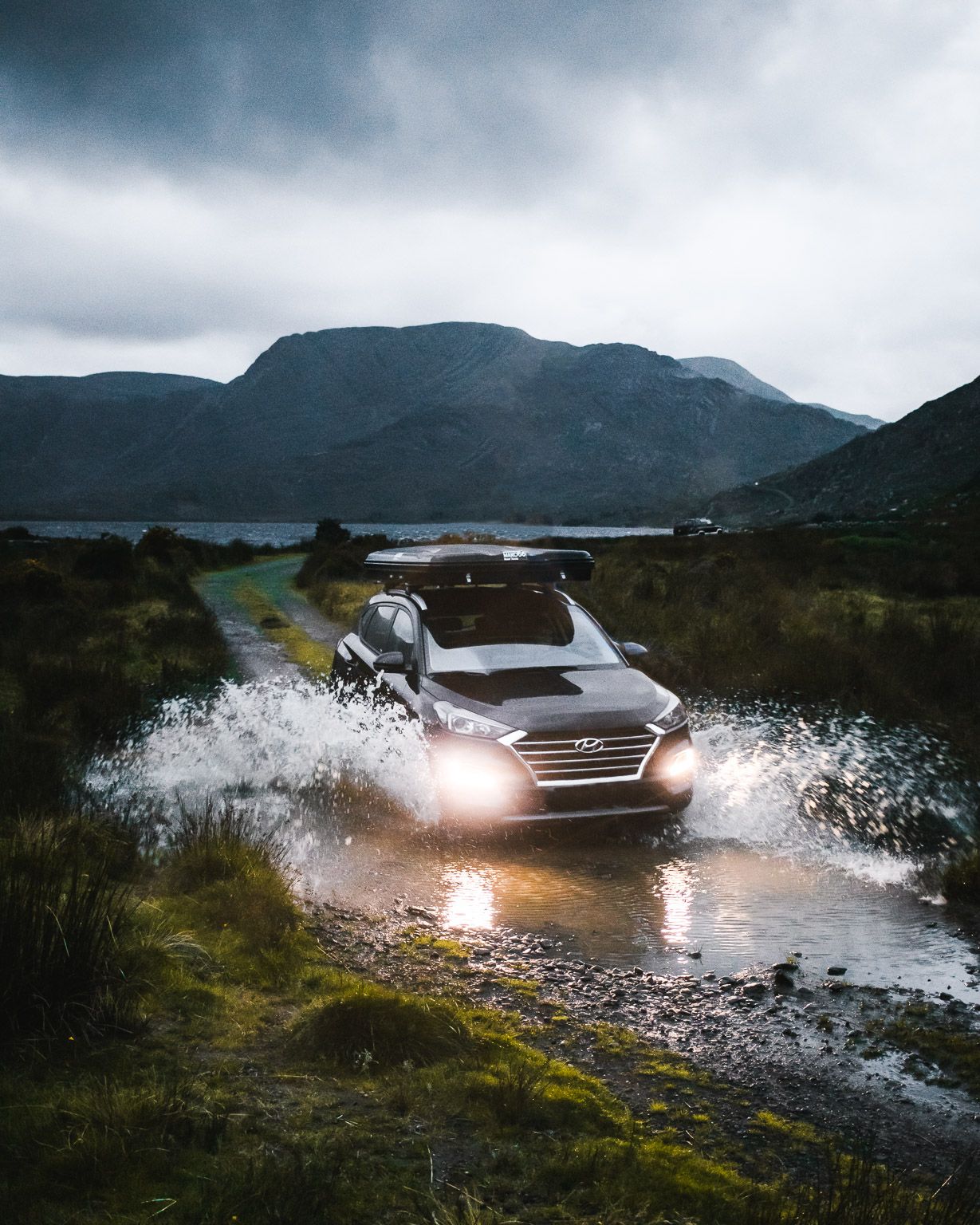 Vehicle with a Mako56 roof tent driving through water