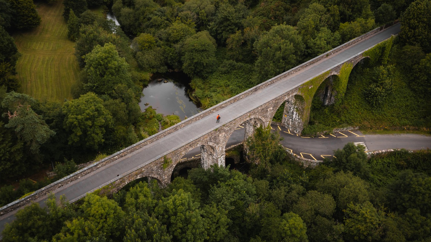 A stone viaduct crossing a wooded river valley