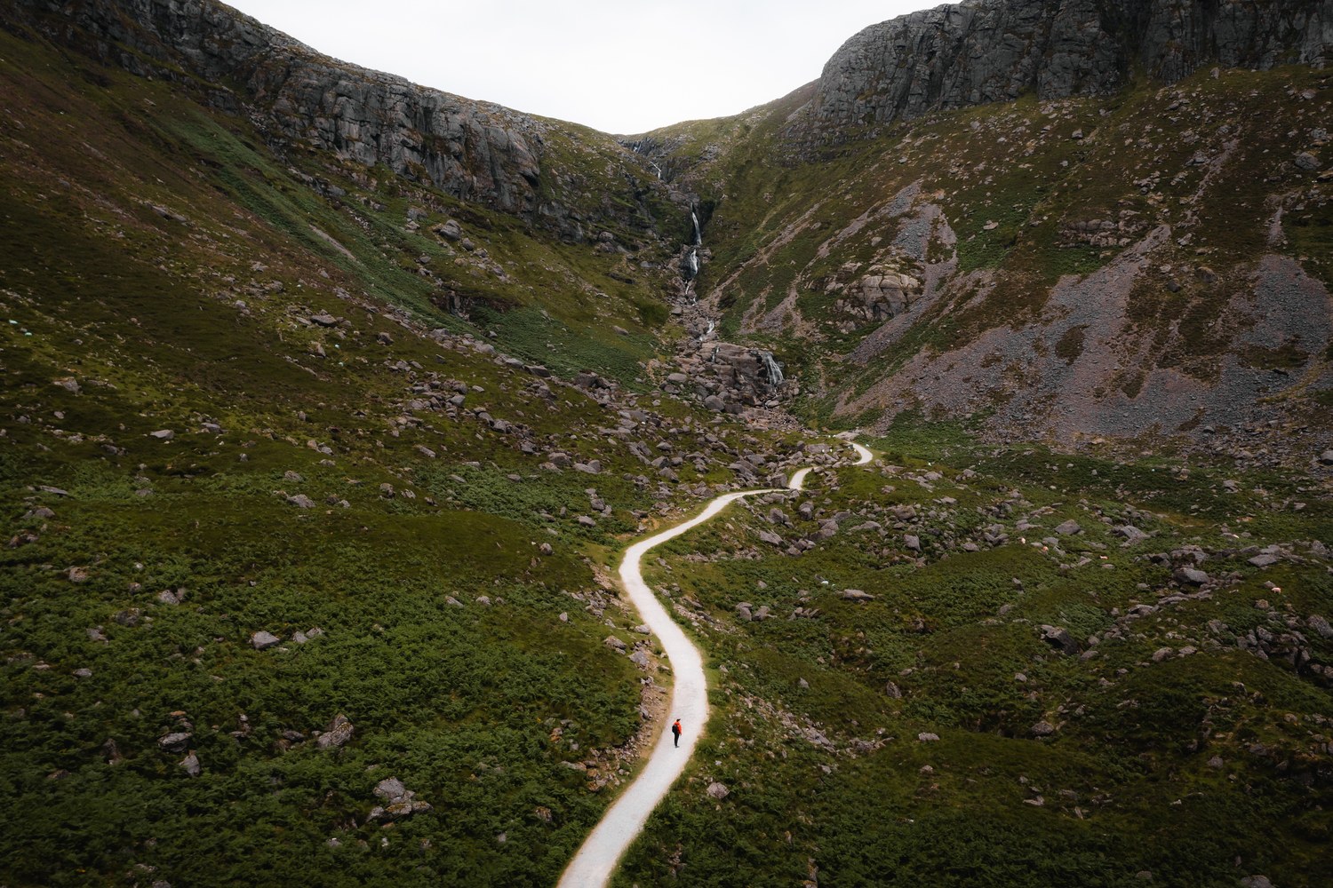 A narrow road winding through a steep mountain pass