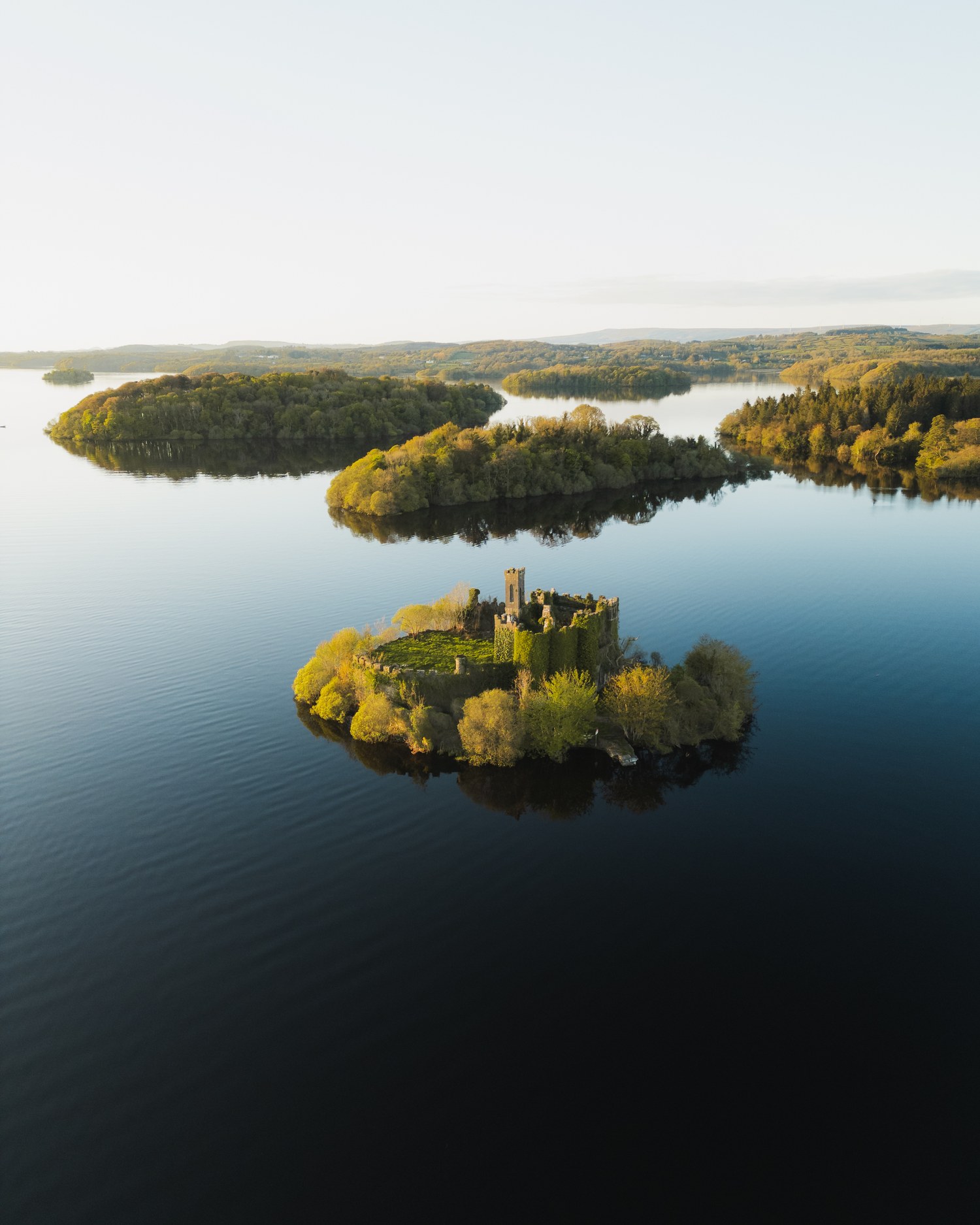 A wooded island on a calm lake, seen from above