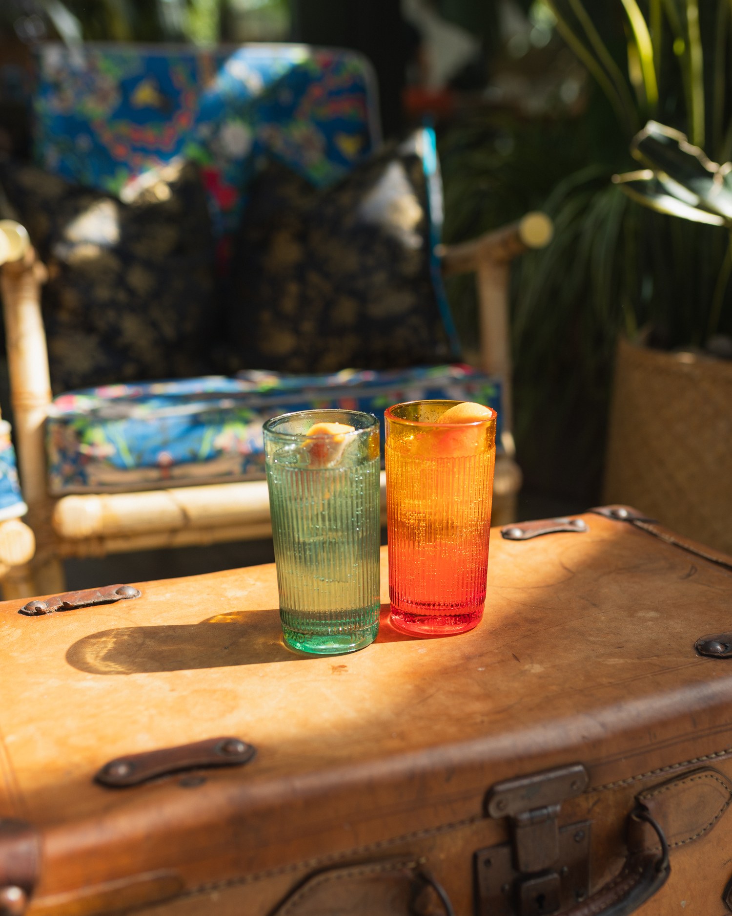 Two long drinks on a leather case aboard the boat