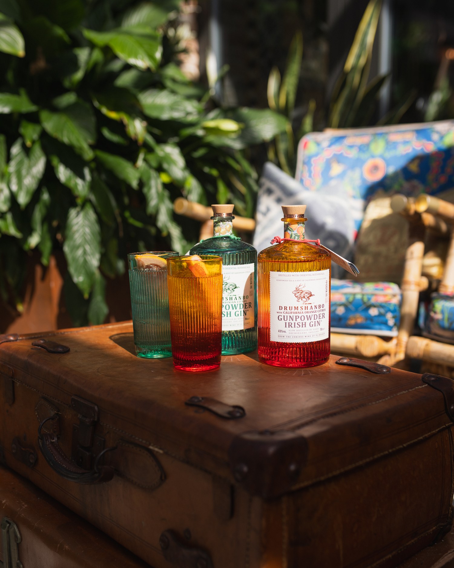 Gin bottles displayed on a leather case aboard the boat