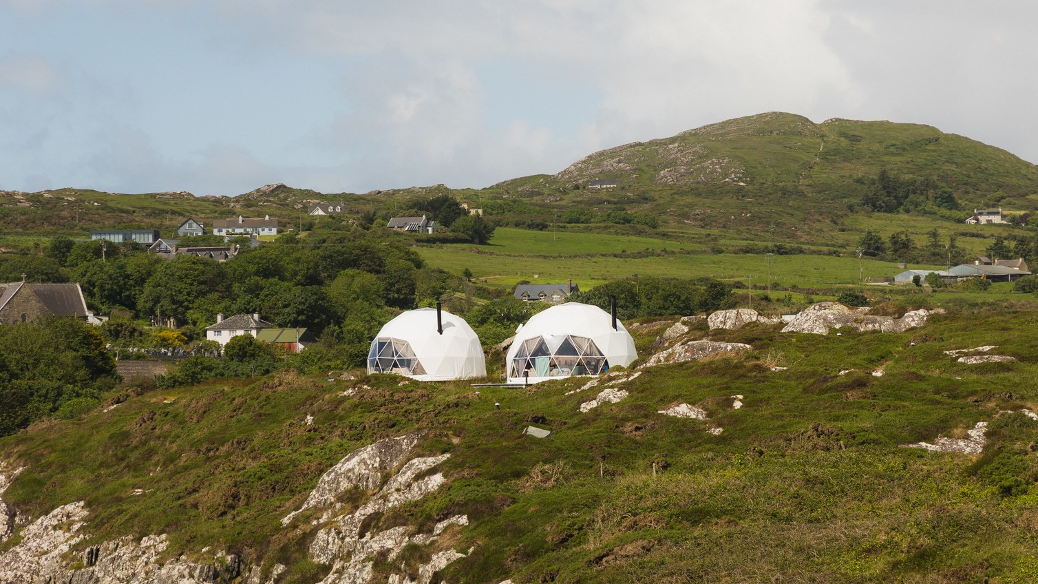 Geodesic domes set in coastal fields