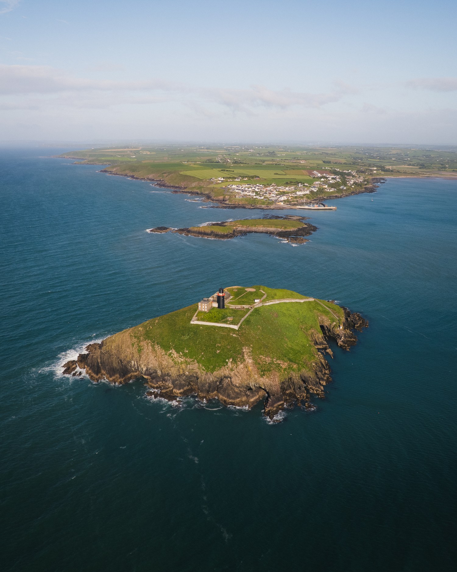 A small island with a ruined fort, ringed by deep blue water