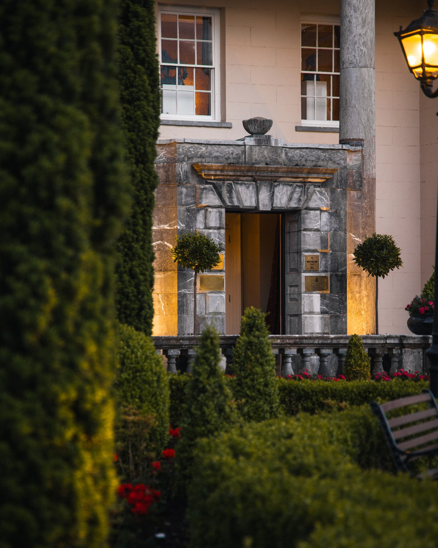 Ivy framing the lamplit entrance of a country house