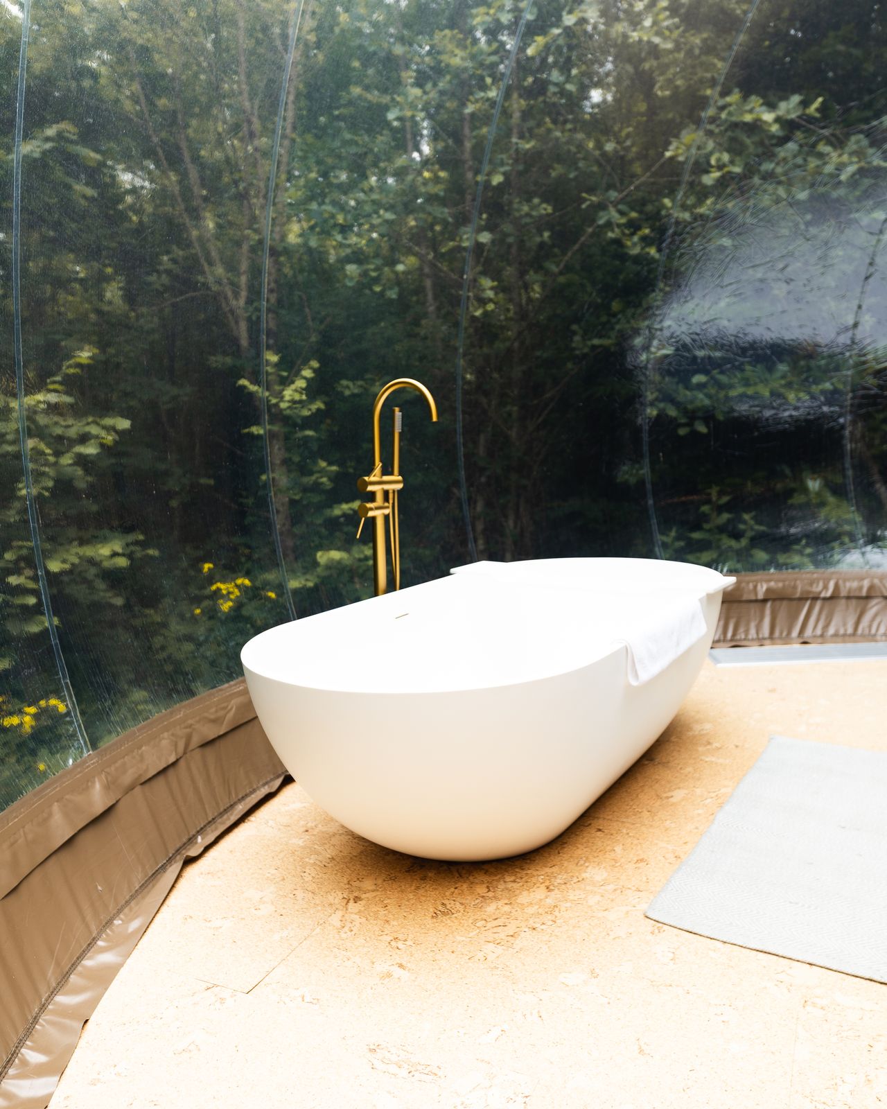 Freestanding round bath with a brass tap
