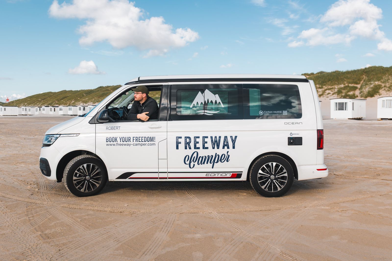 The van on a wide empty beach