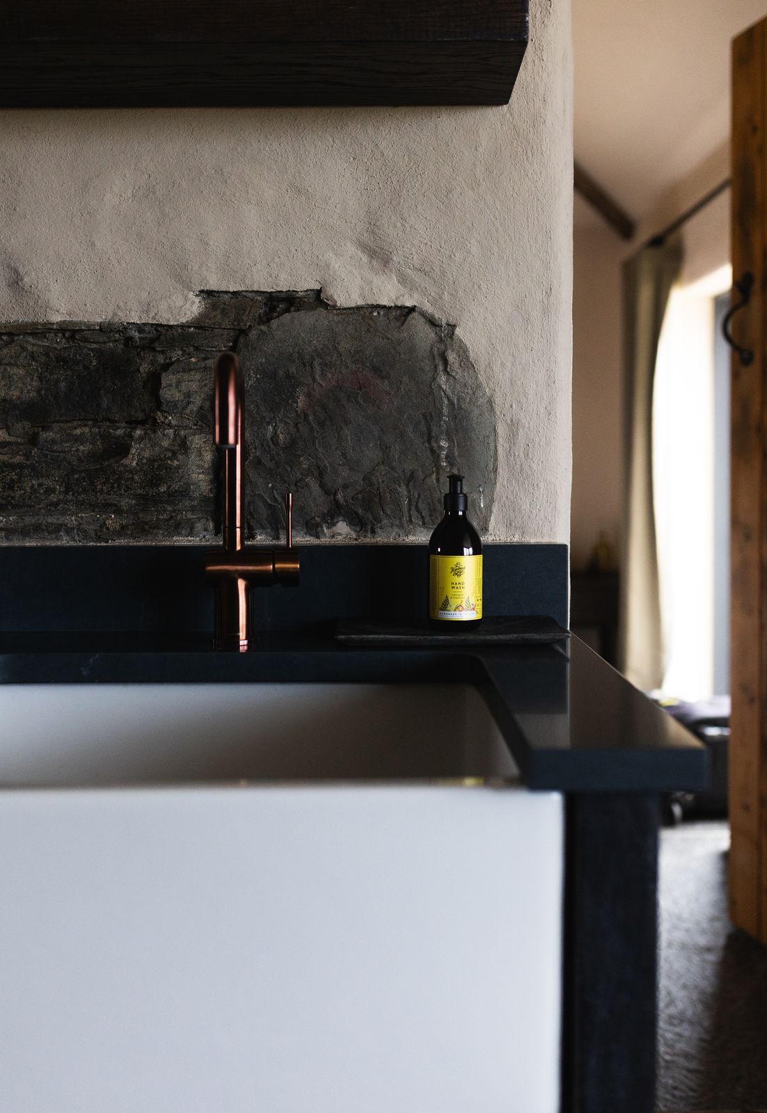 Stone sink with a raw brass tap
