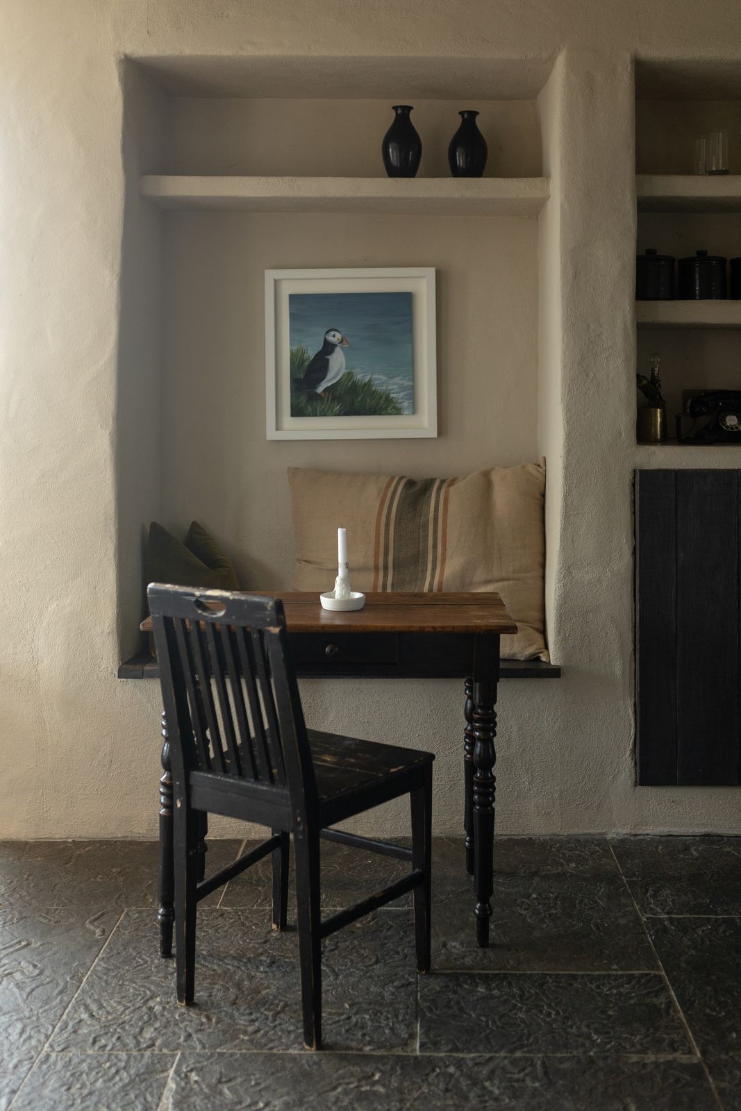 Dining nook with a dark timber table and a painting