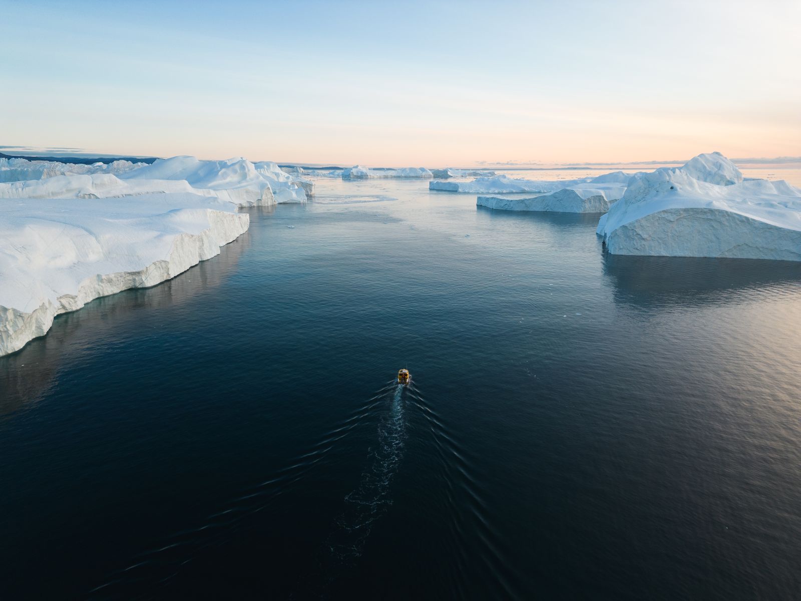 Icebergs drifting on flat calm water