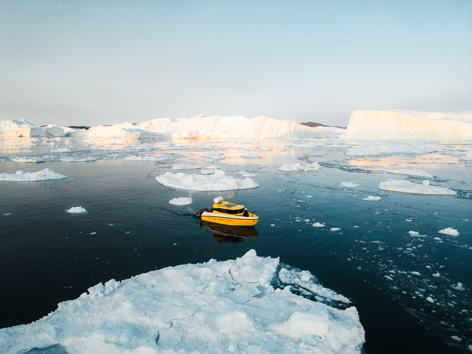 Golden light across the ice and open water