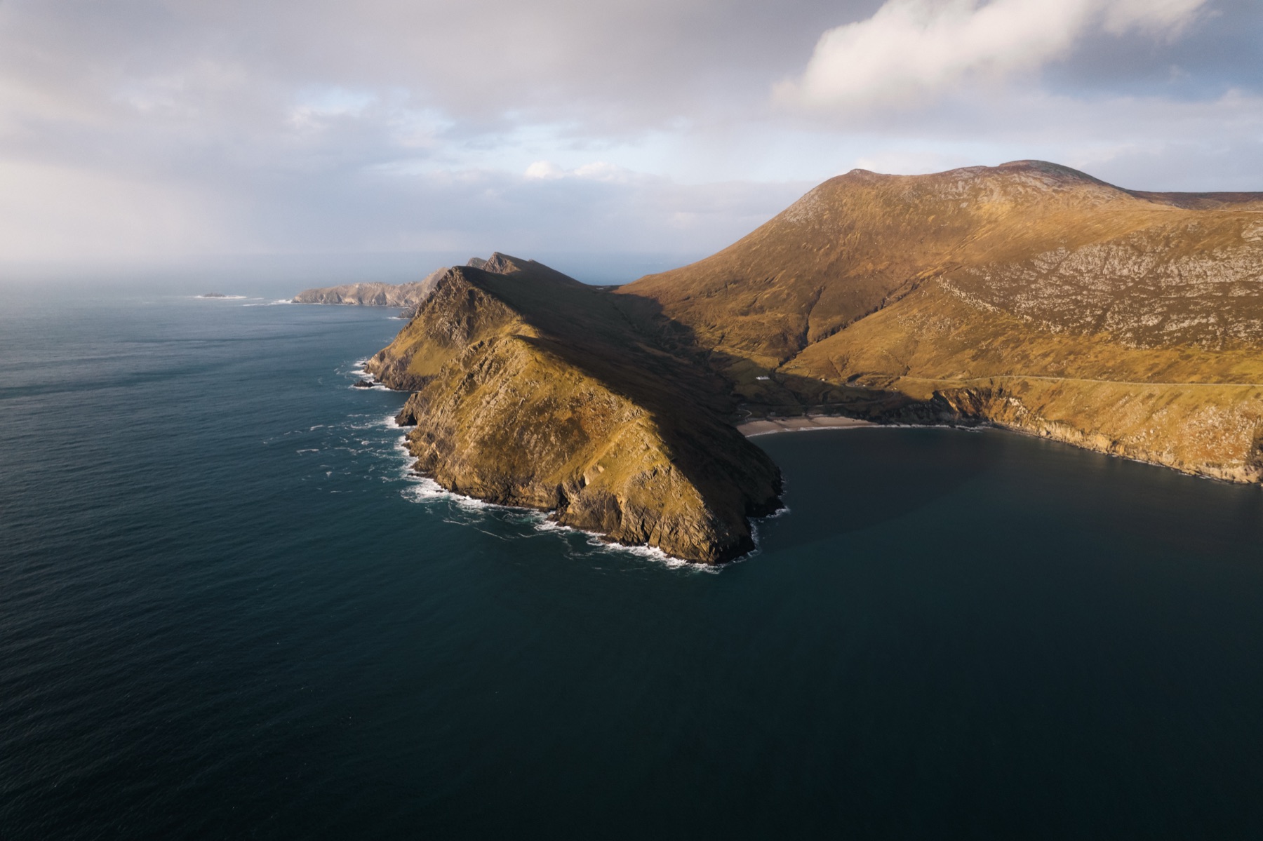 The crescent of Keem Bay below the headland on Achill Island, County Mayo