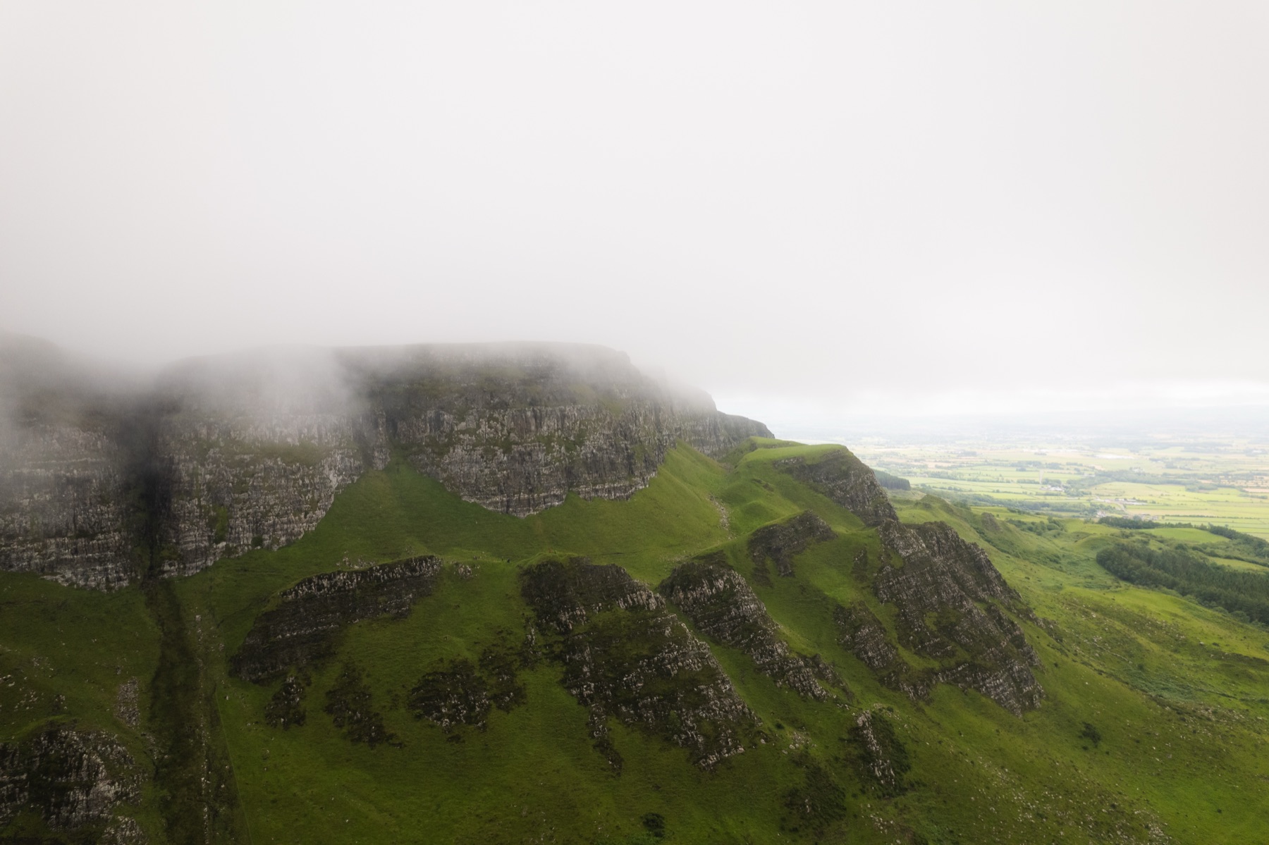 The basalt escarpment of Binevenagh rising above the coastal plain, County Derry