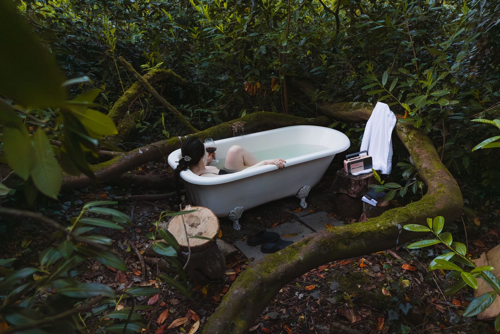 Freestanding bath in the woodland at dusk