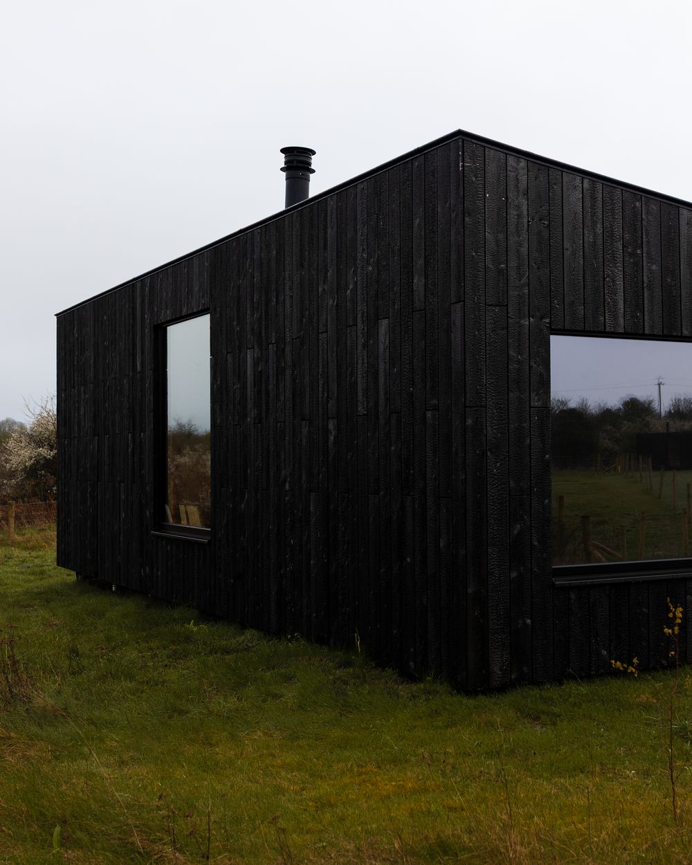 A Slow Cabins off grid cabin sitting in open Irish countryside